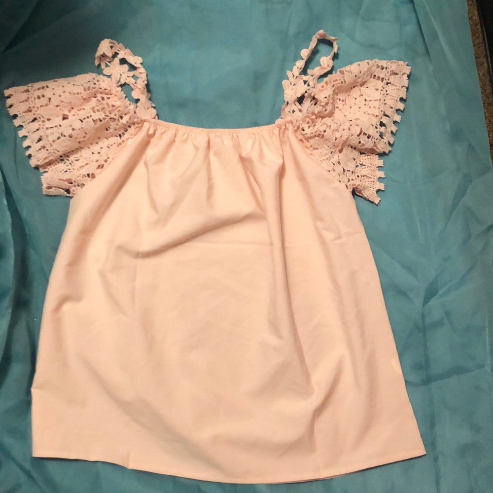 Soft pink blouse with crochet sleeves